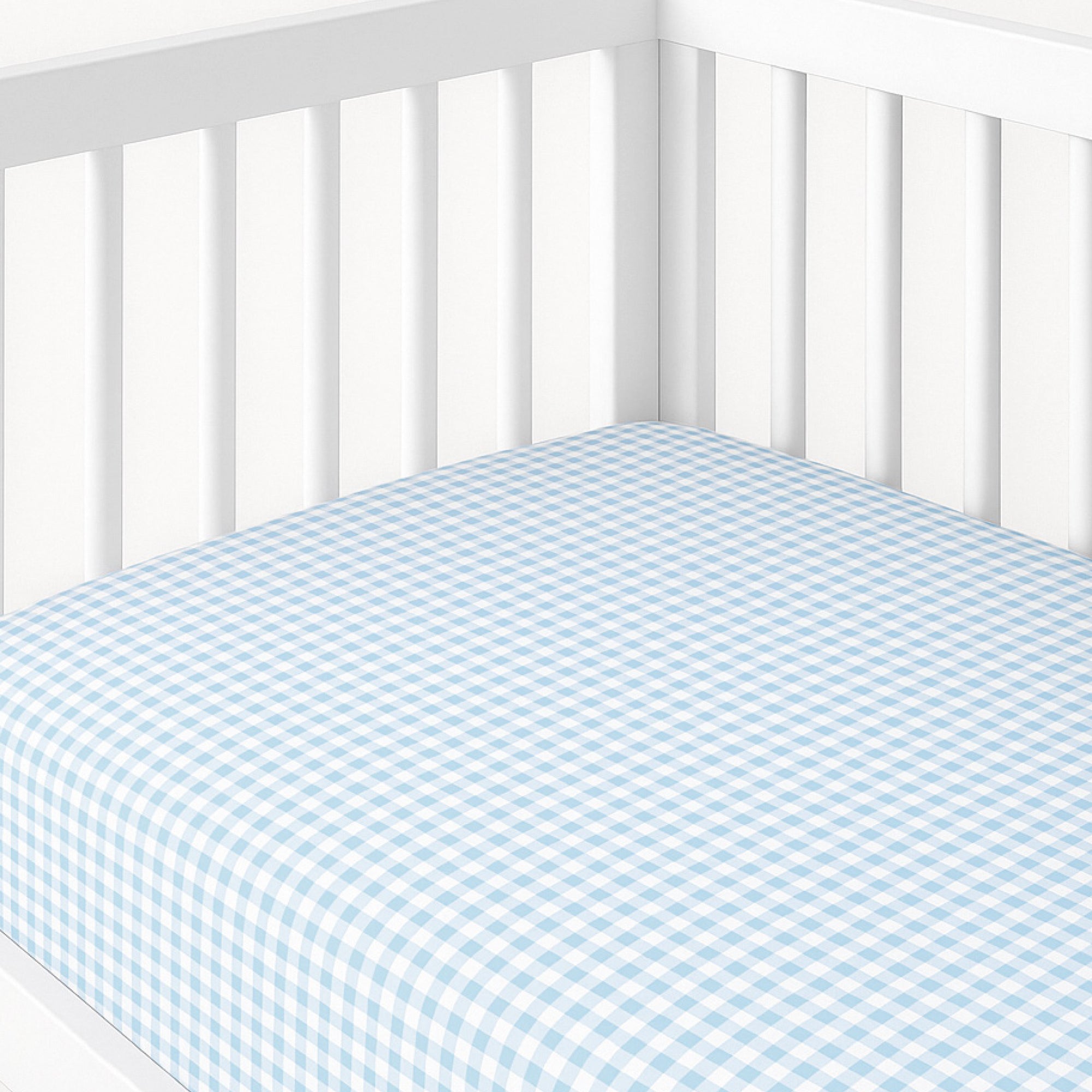Crib with blue and white checkered fitted sheet on a white background