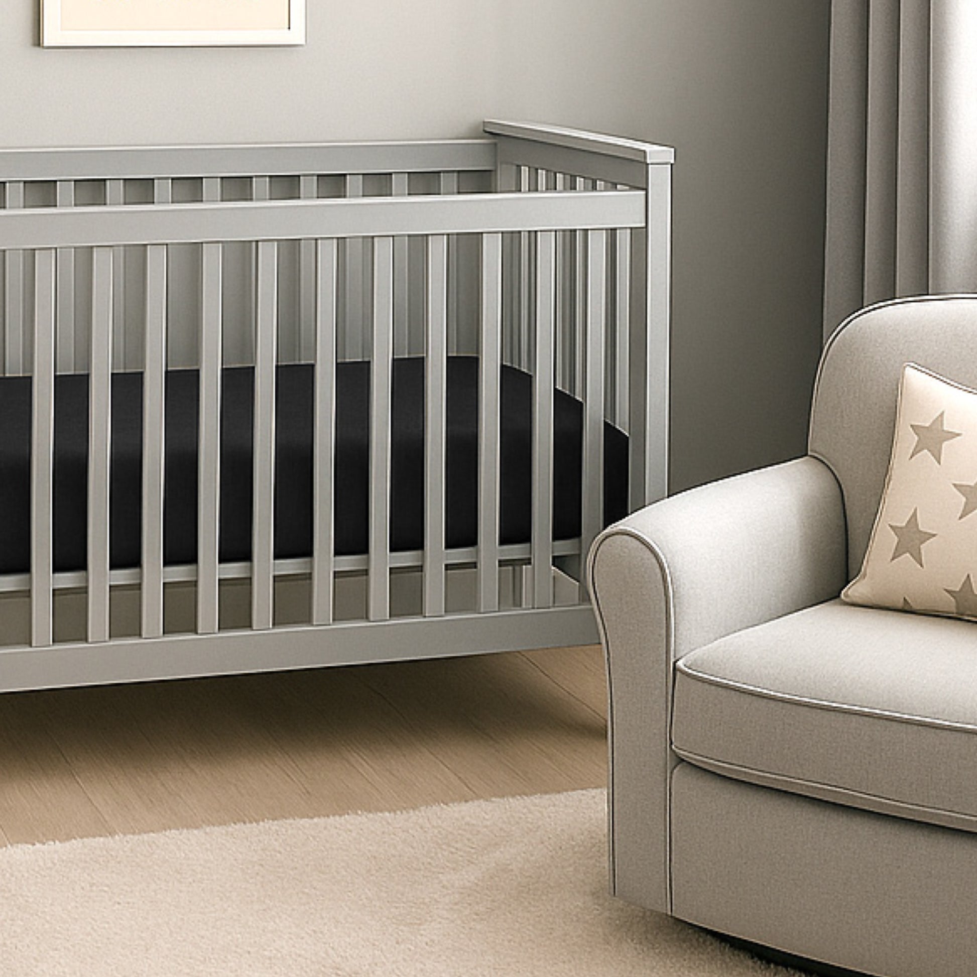 Gray crib and beige armchair with star-patterned pillow in a nursery setting