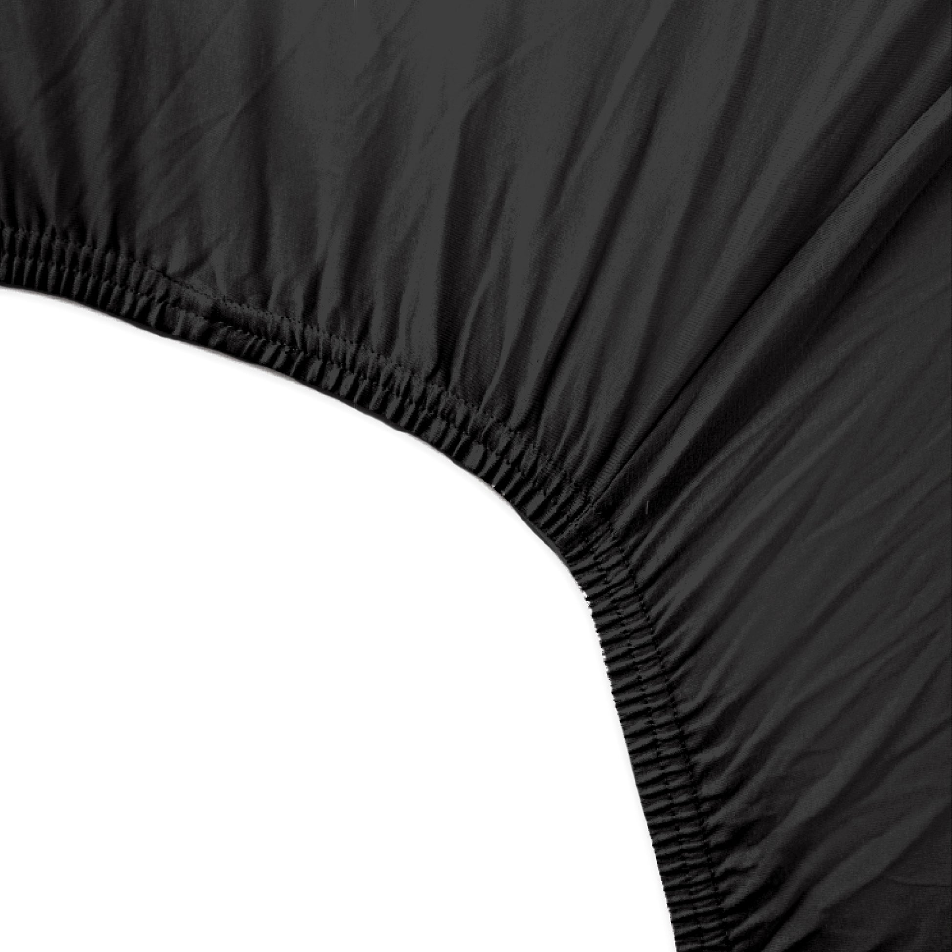 Black fitted sheet corner on a white background