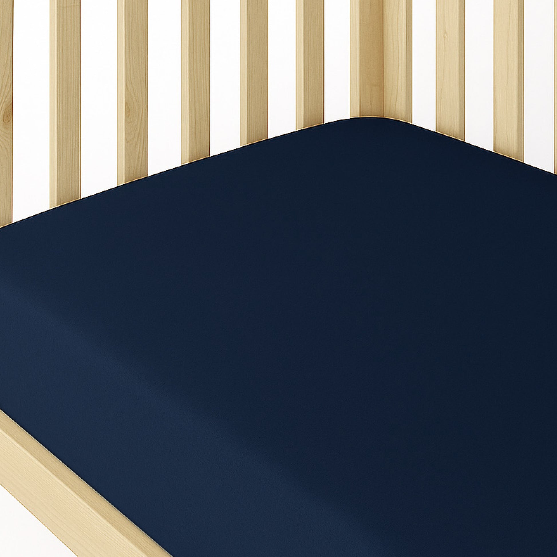 Navy blue mattress cover on a wooden bed frame with white background