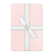 Pink fabric with a white ribbon on a white background