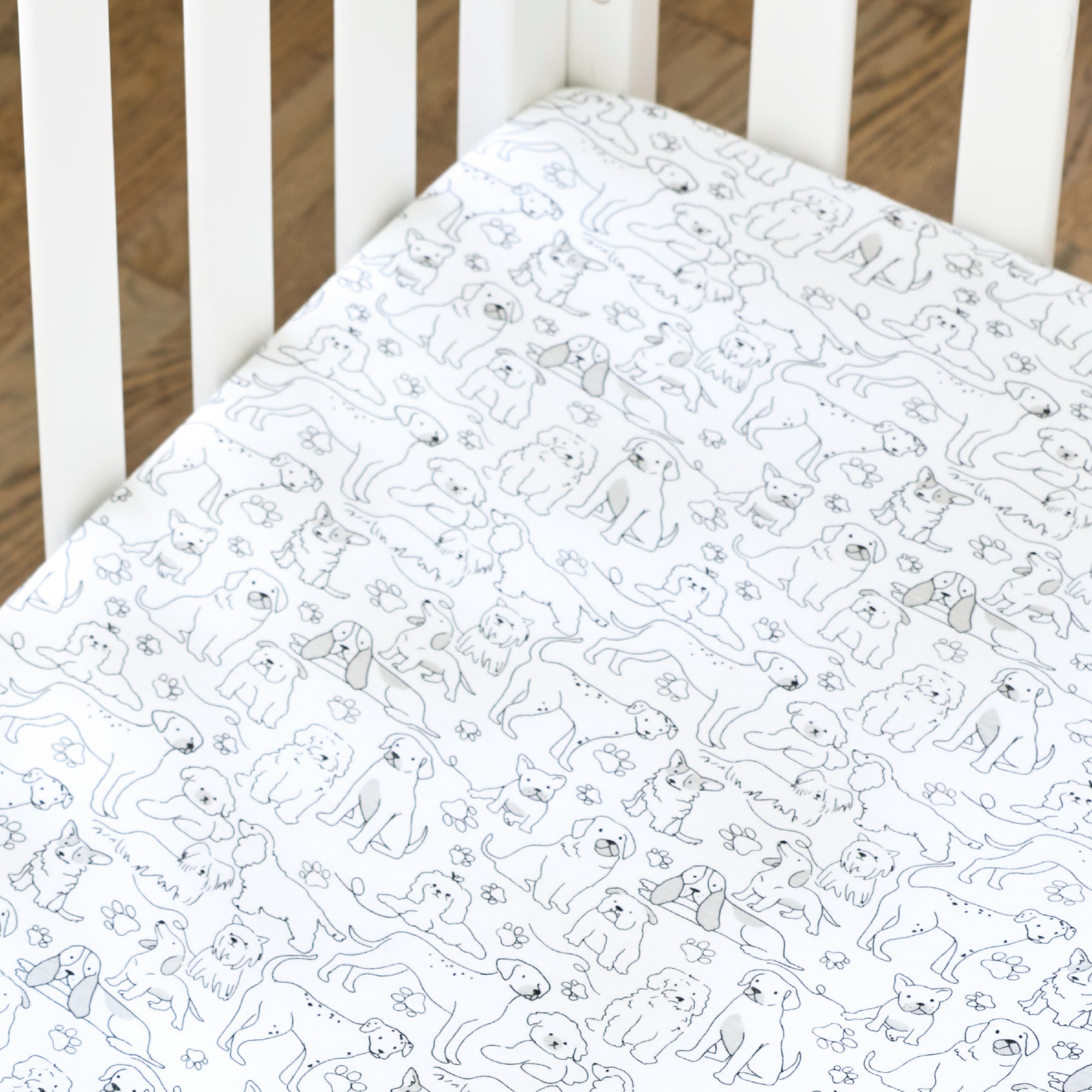Butterblu Frankie fitted crib sheet in Puppy Party — GOTS-certified organic cotton crib sheet for standard cribs