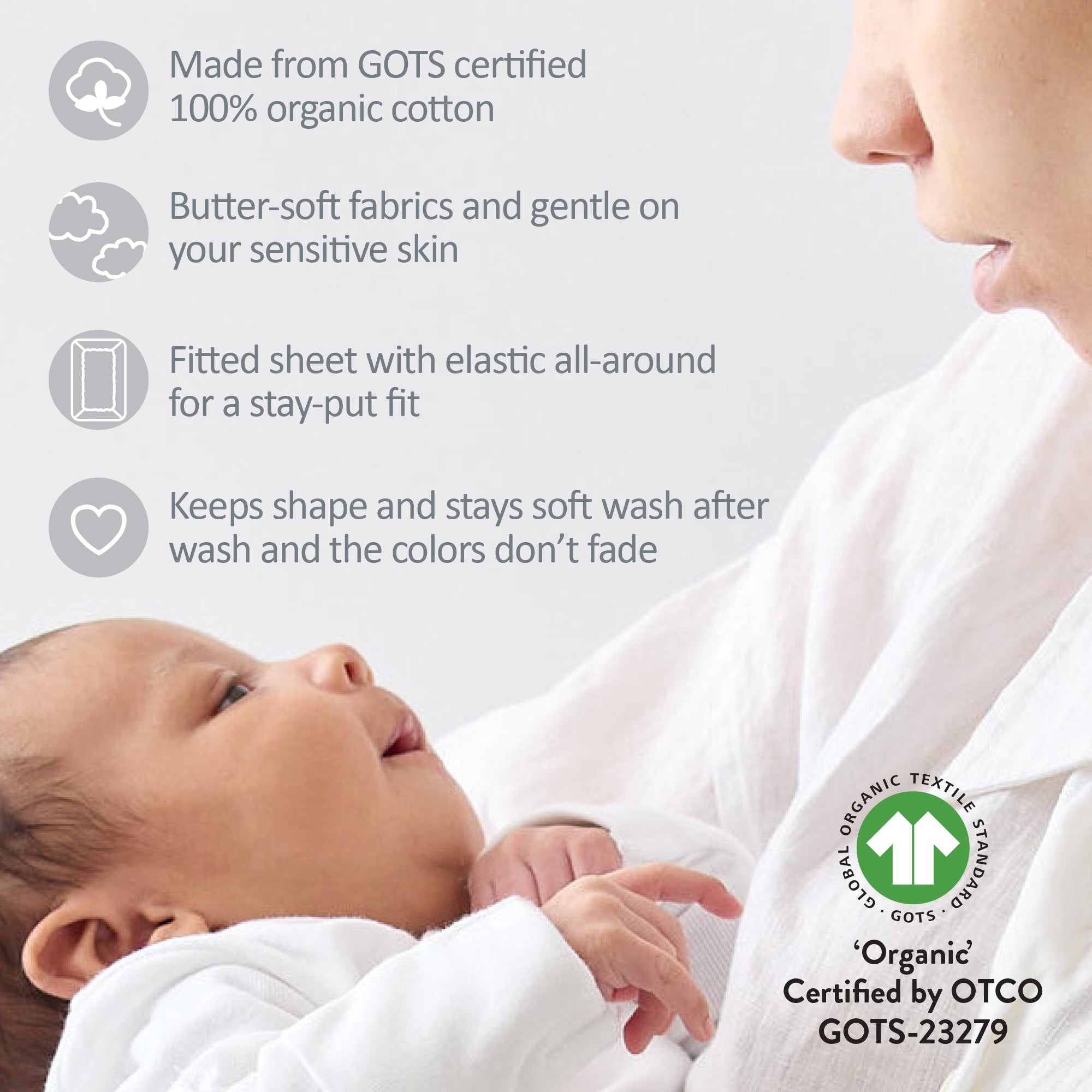 Baby wrapped in a fitted sheet with GOTS certification logo and text about organic cotton.