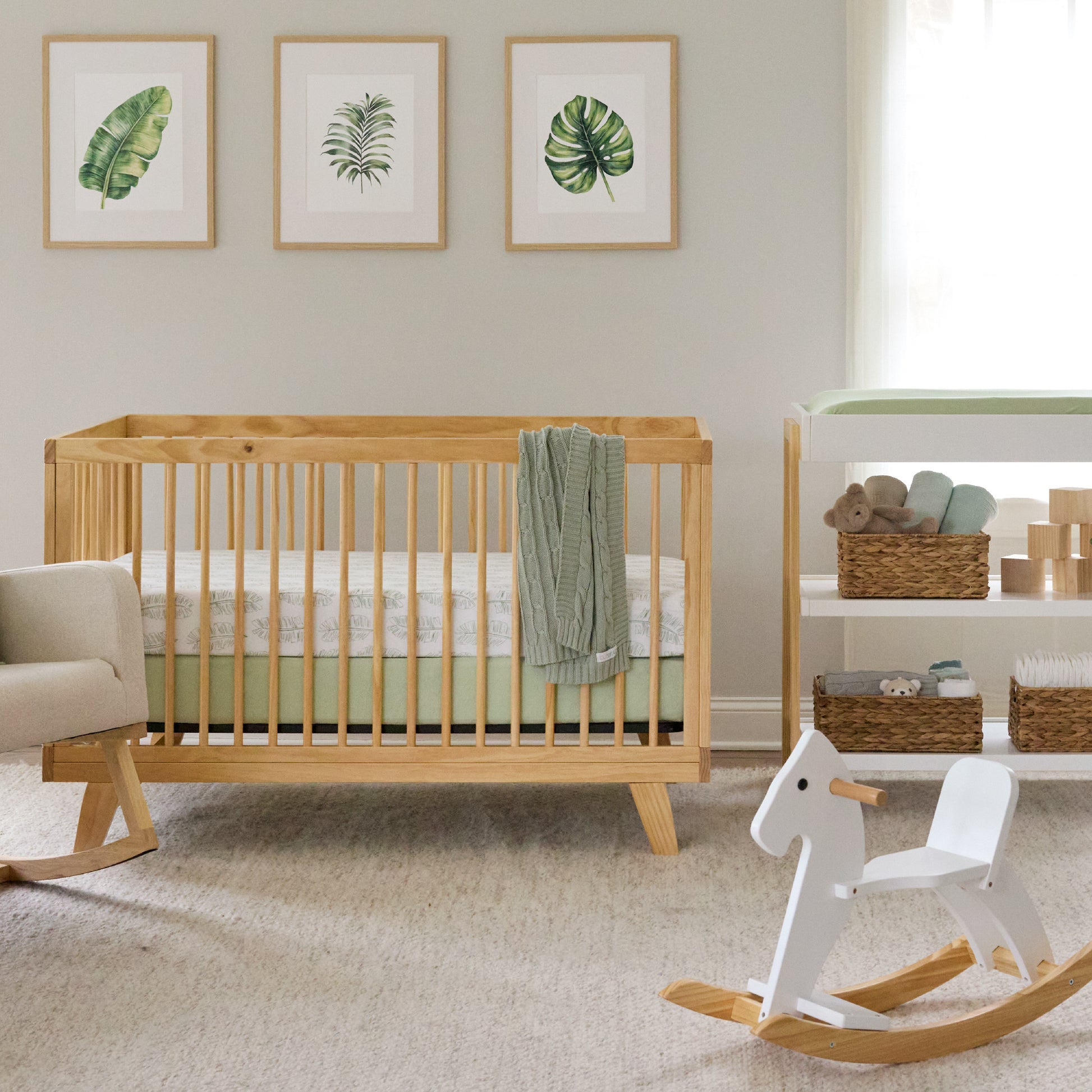 Nursery room with wooden crib, rocking horse, and shelves.