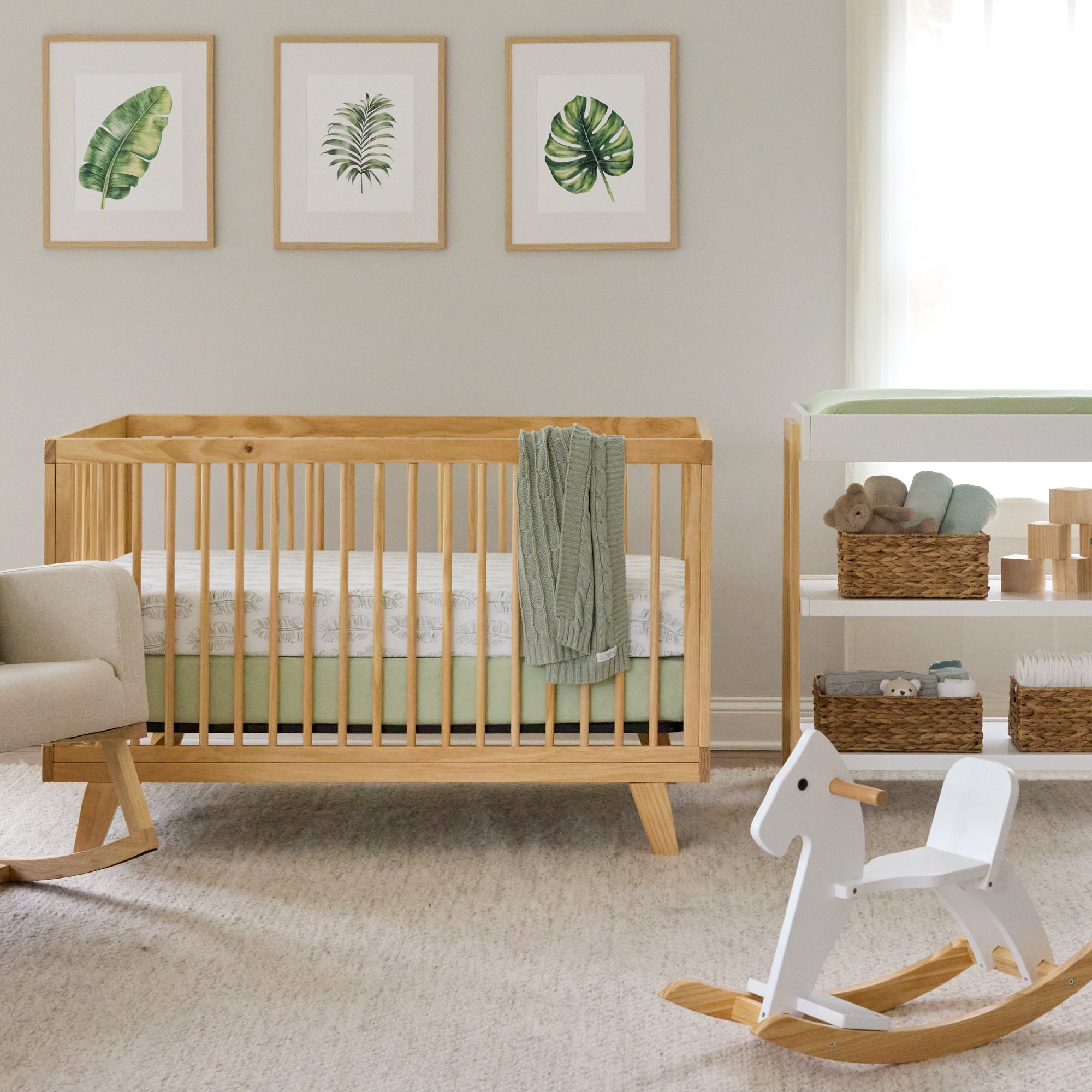 Nursery room with wooden crib, rocking horse, and shelves.