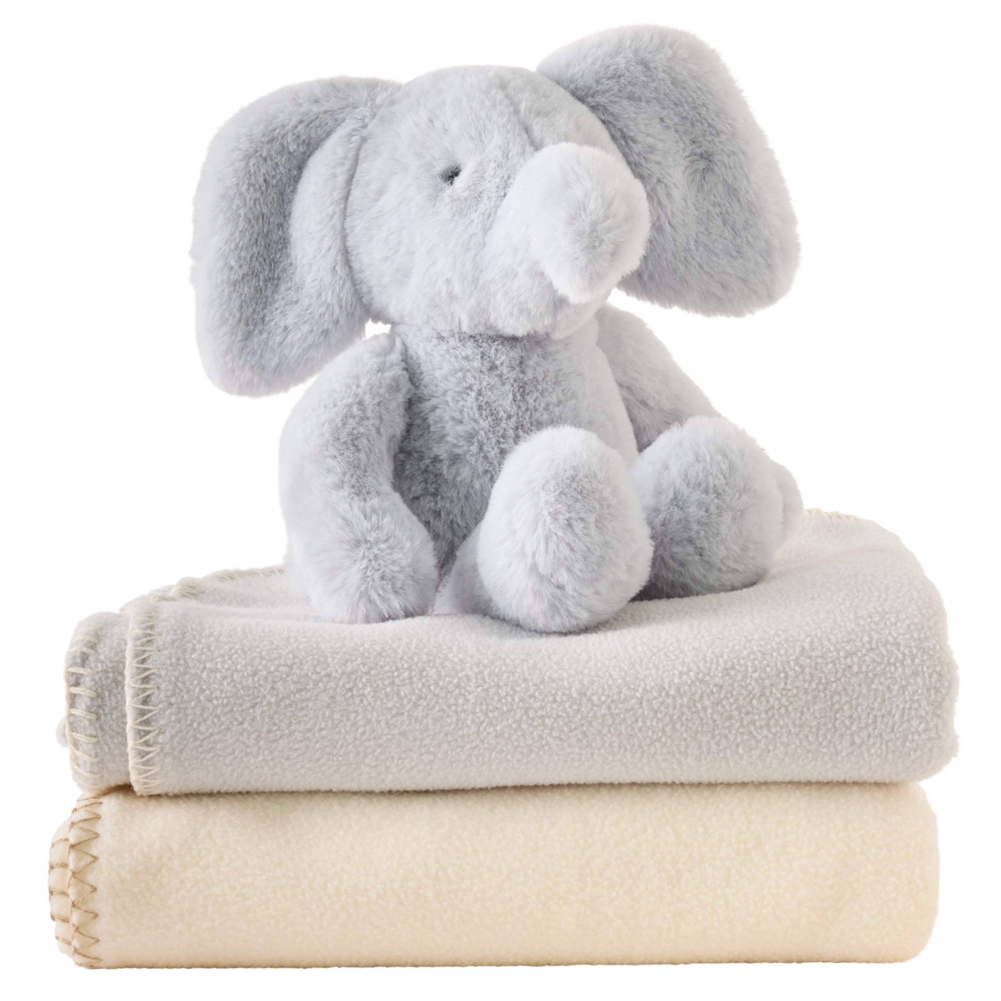 Plush elephant toy on top of two folded blankets, one gray and one beige, on a white background.