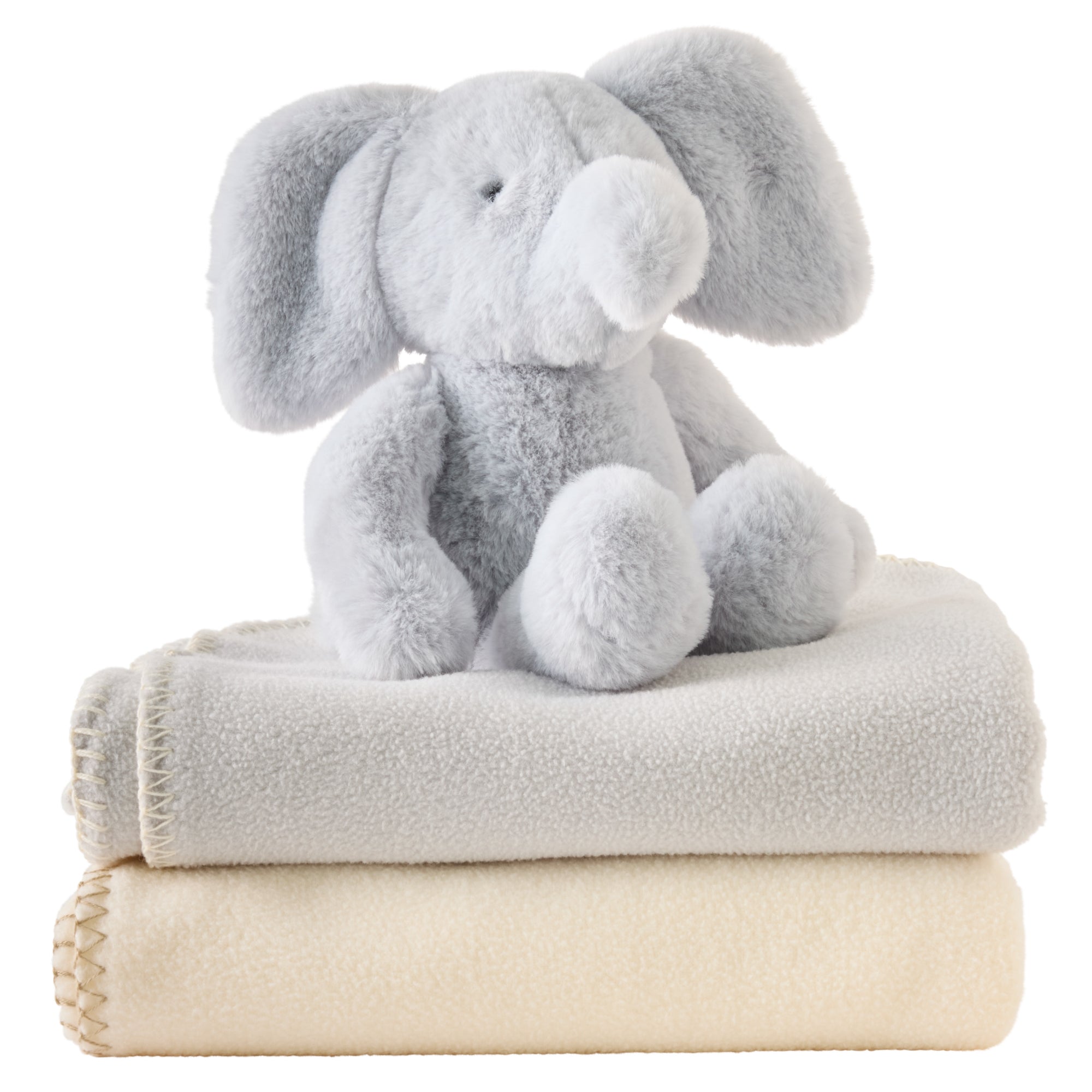 Plush elephant toy on top of two folded blankets, one gray and one beige, on a white background.