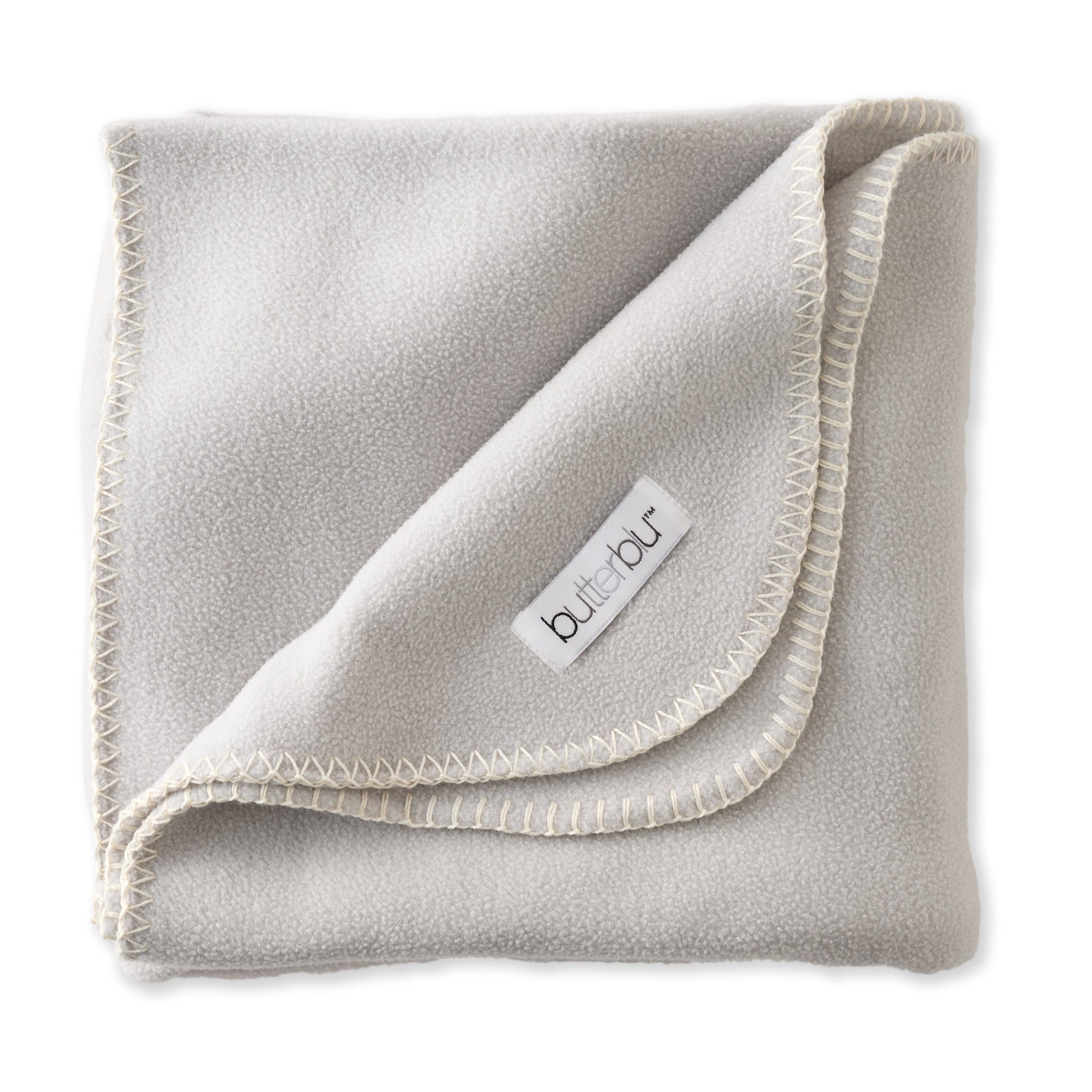 Folded gray fleece blanket with a brand label on a white background