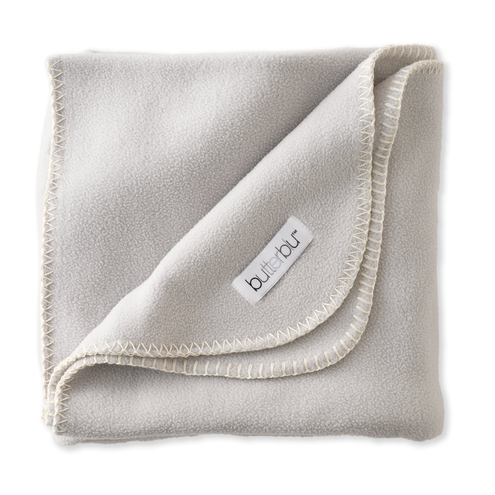 Folded gray fleece blanket with a brand label on a white background