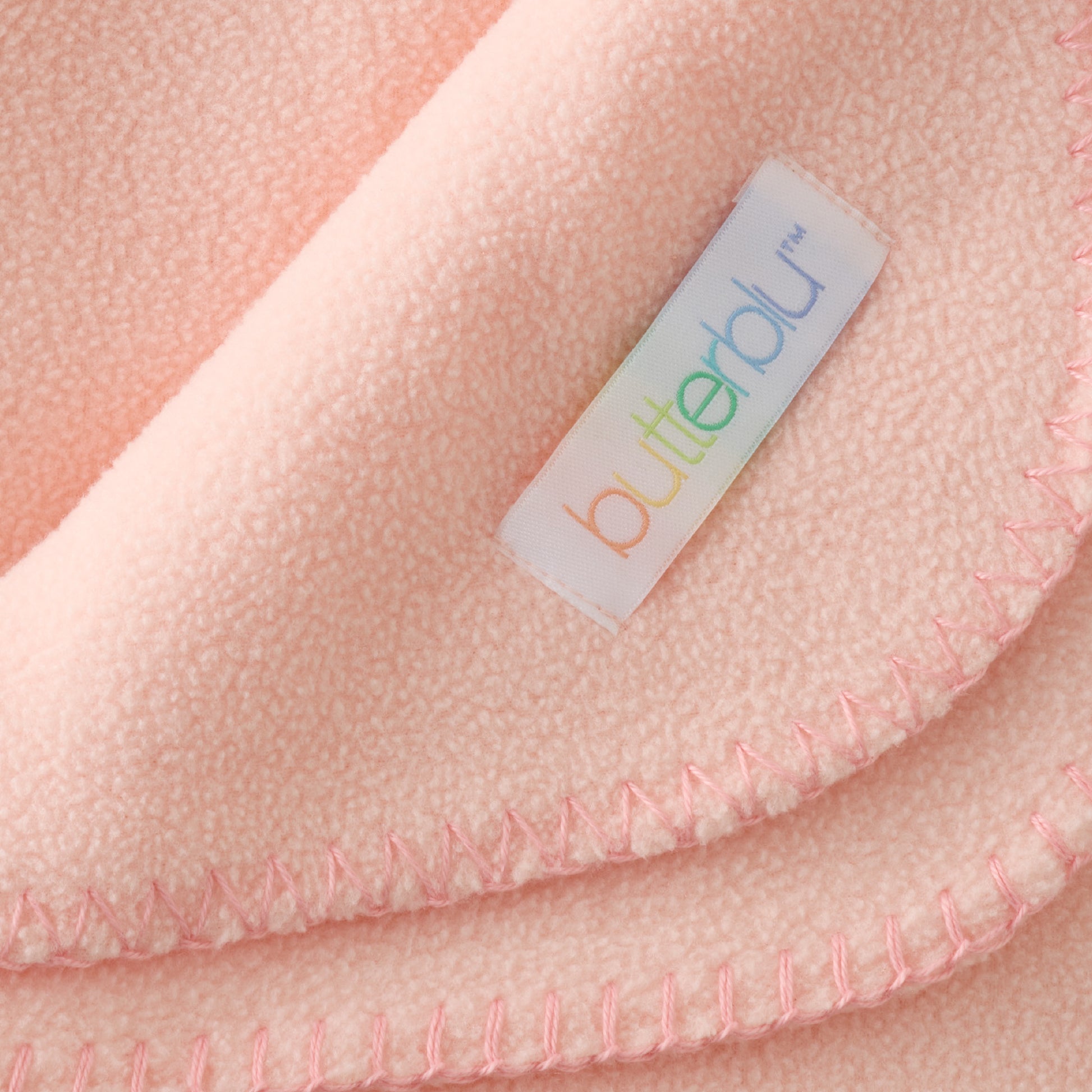 Close-up of a pink fabric with a 'butterfly' label.