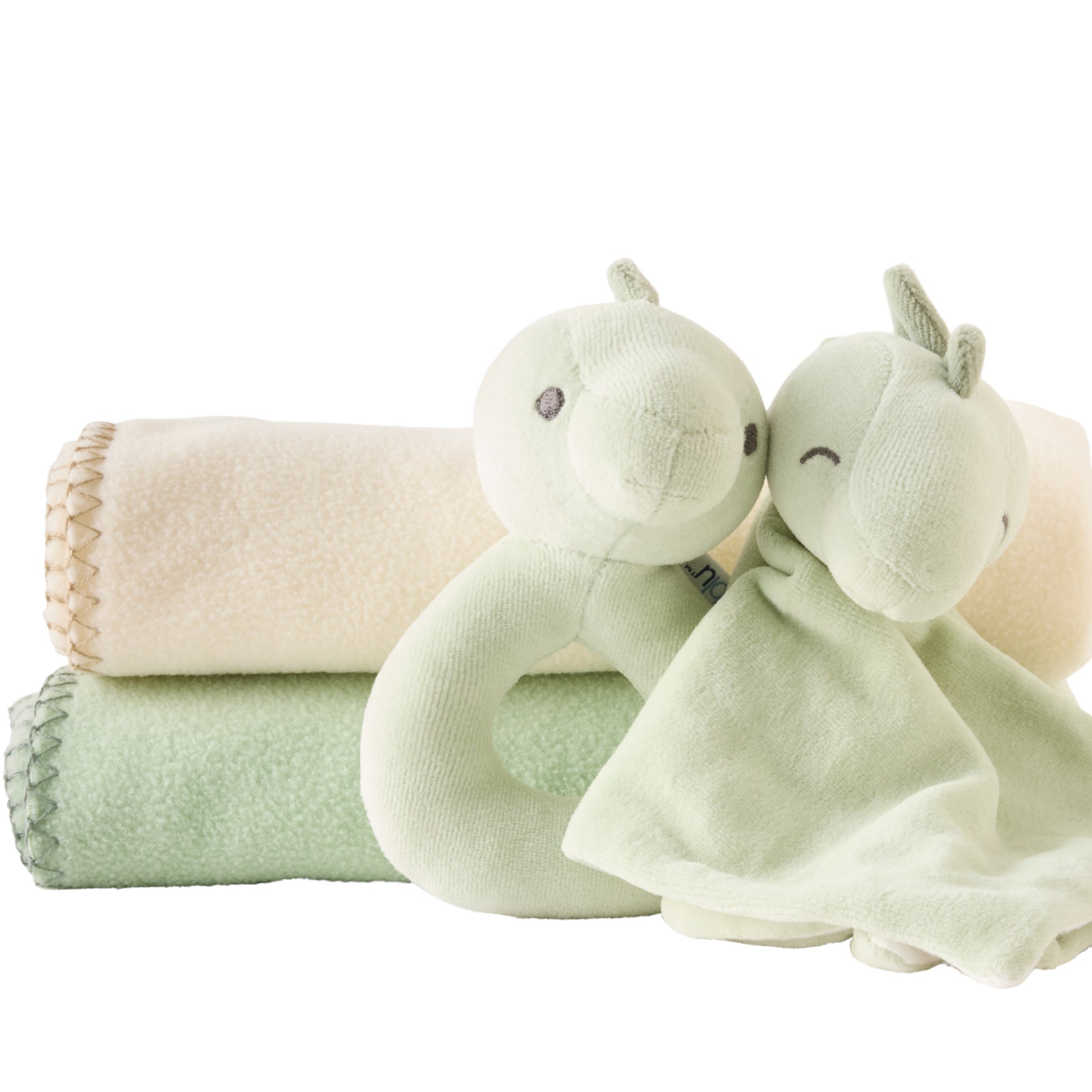 Two green plush toys and a beige blanket on a white background