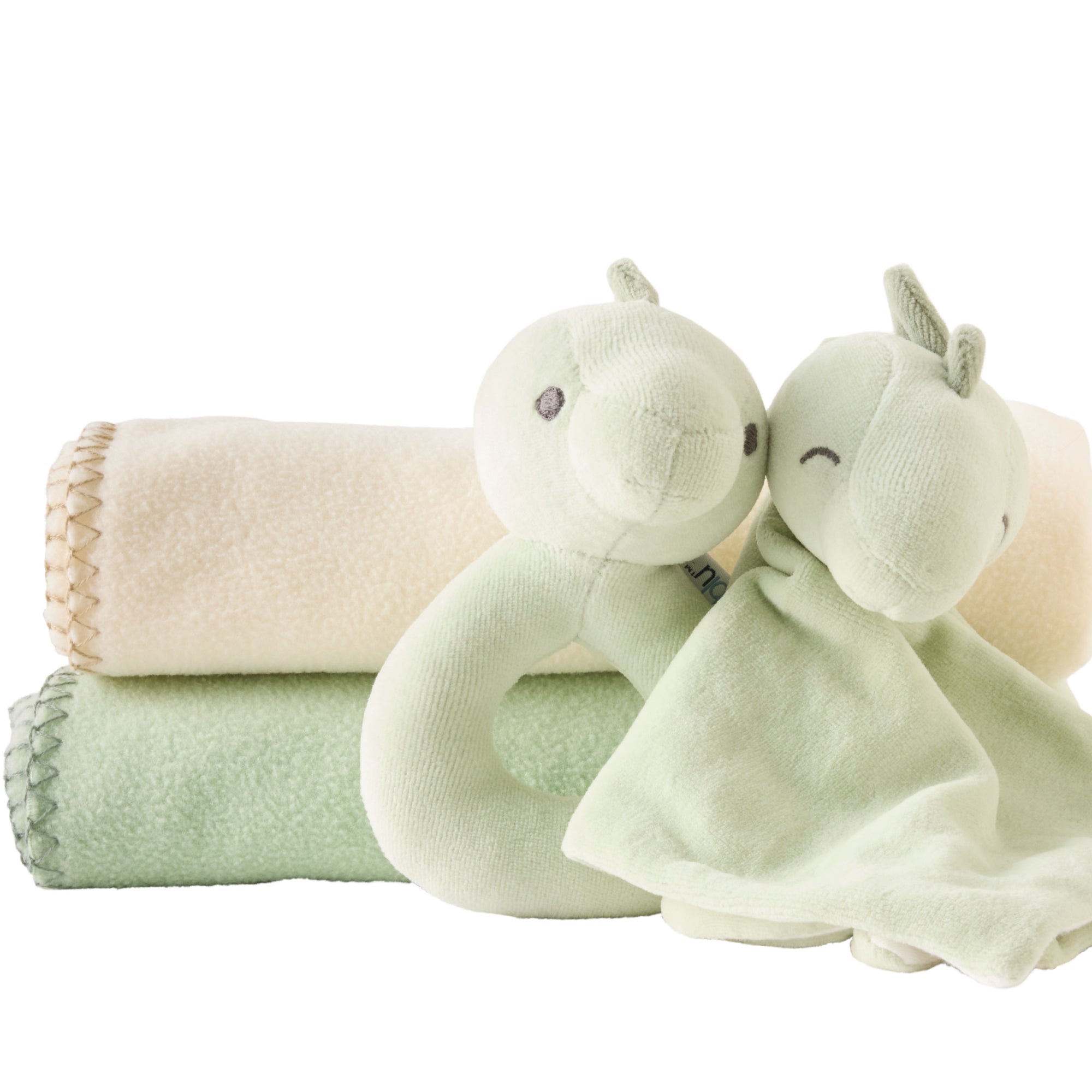 Two green plush toys and a beige blanket on a white background