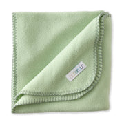 Folded green blanket with a brand label on a white background
