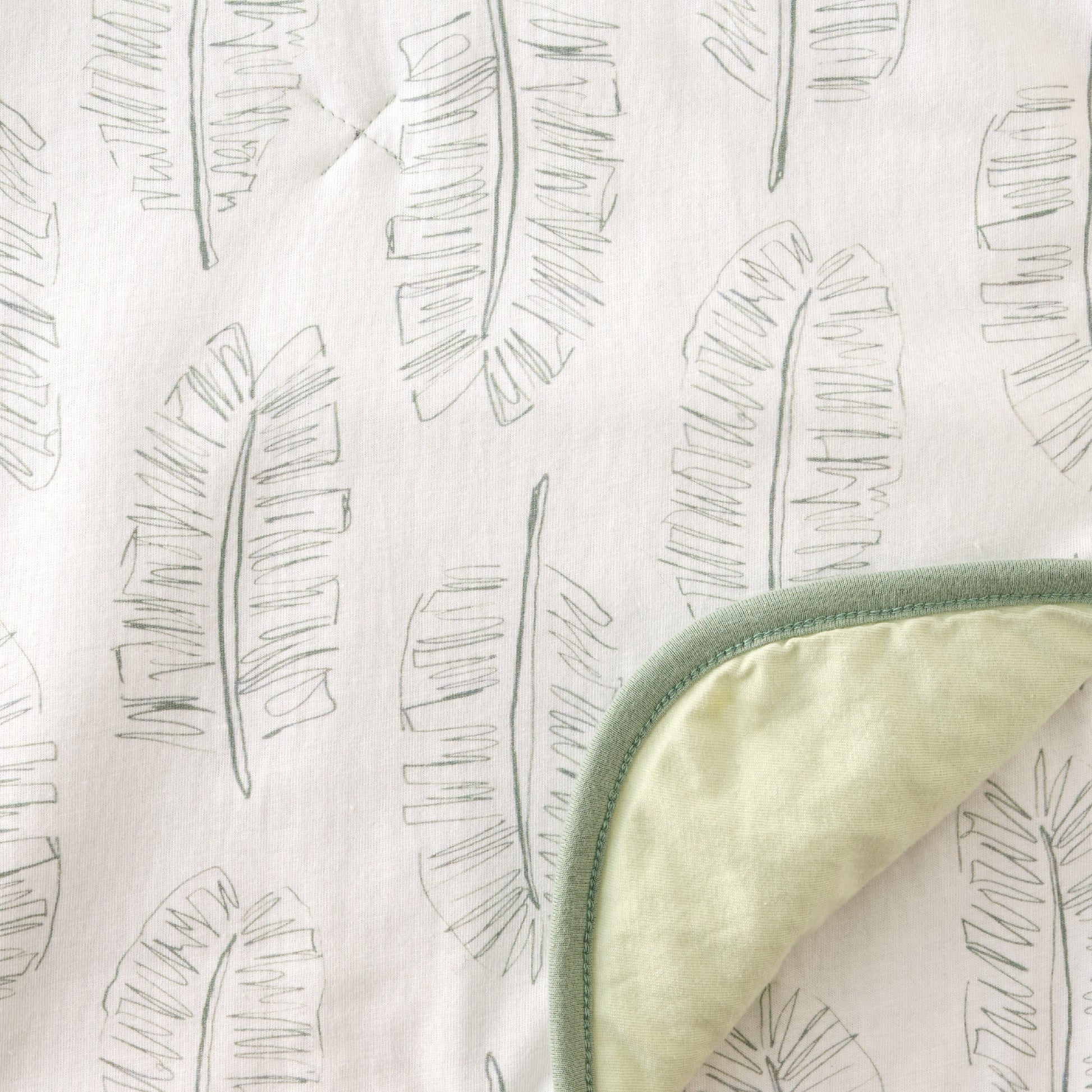 Textile with leaf pattern and green border