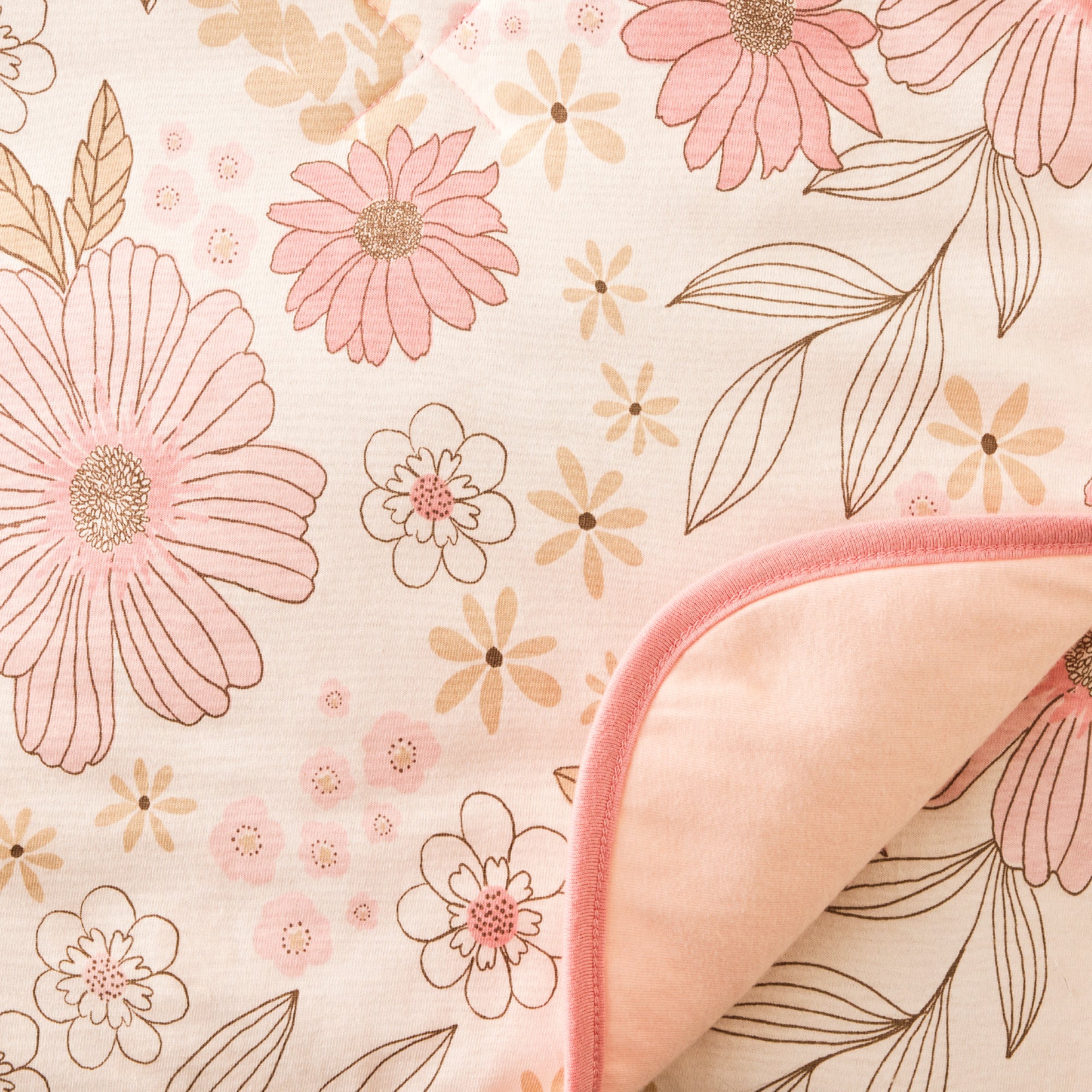 Floral patterned fabric with pink flowers and leaves on a light background