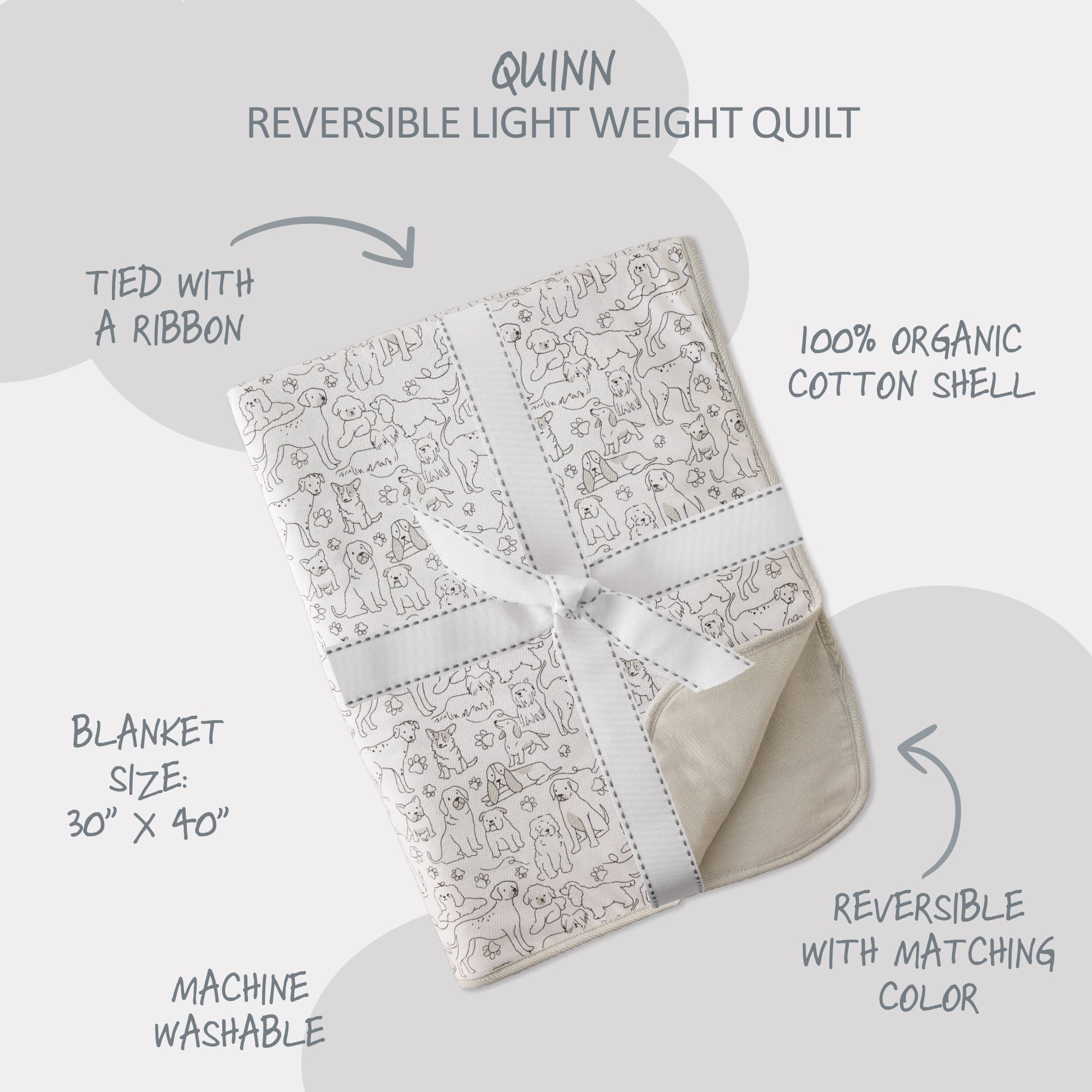 Reversible light weight quilt with dog pattern and white ribbon, labeled 'Quinn'.