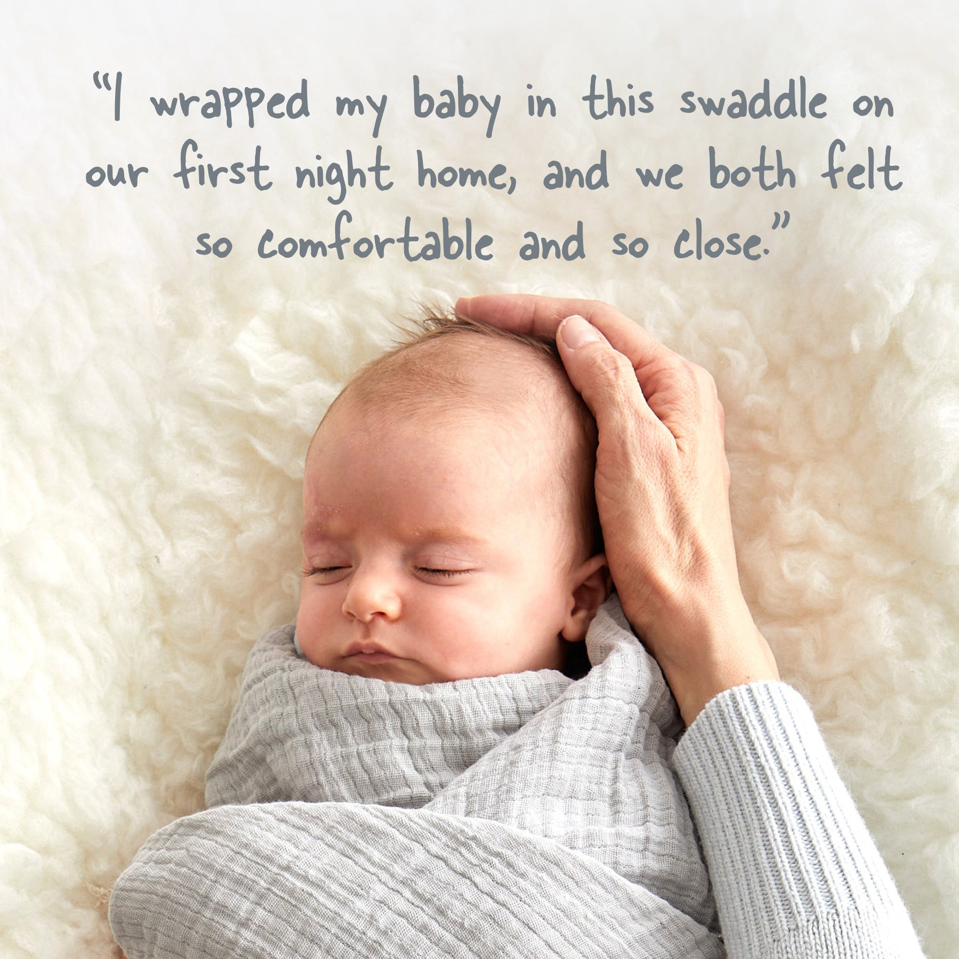 Newborn baby wrapped in a swaddle with a hand on its head, lying on a soft surface.