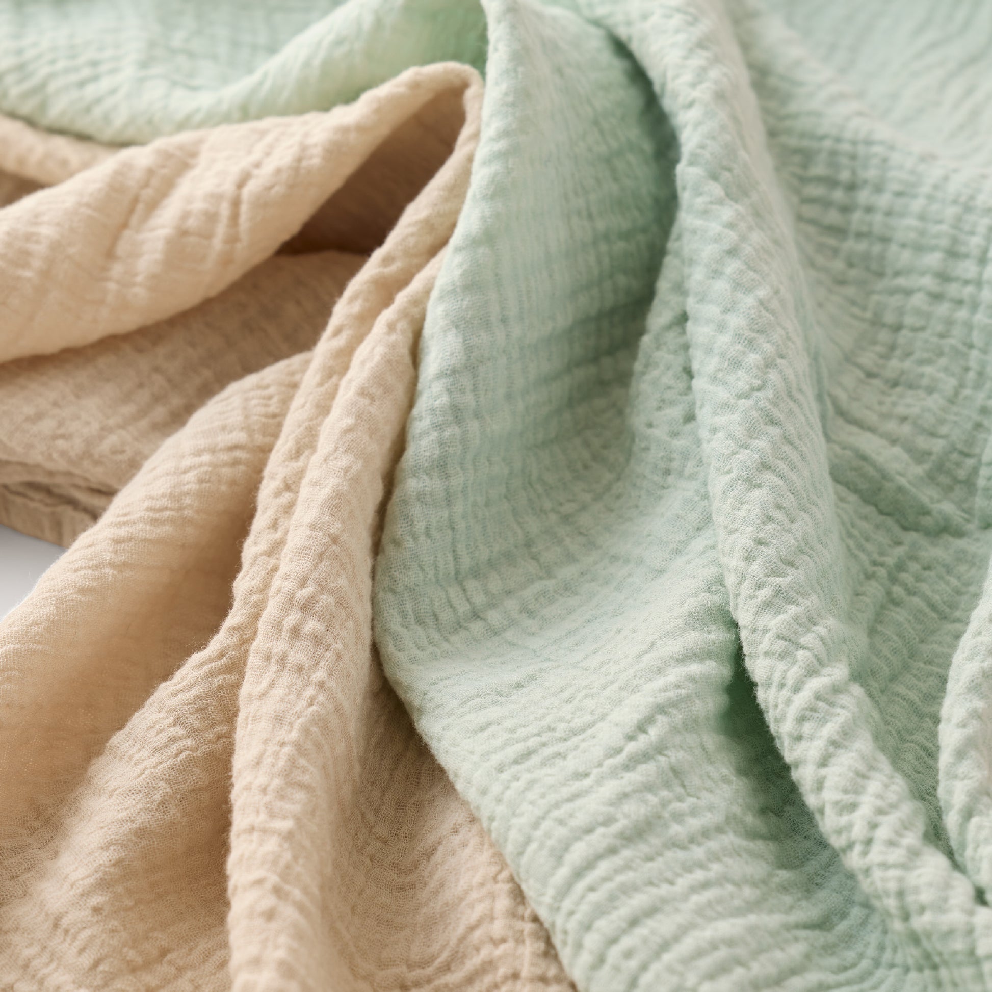 Close-up of soft, textured fabric in pastel colors.