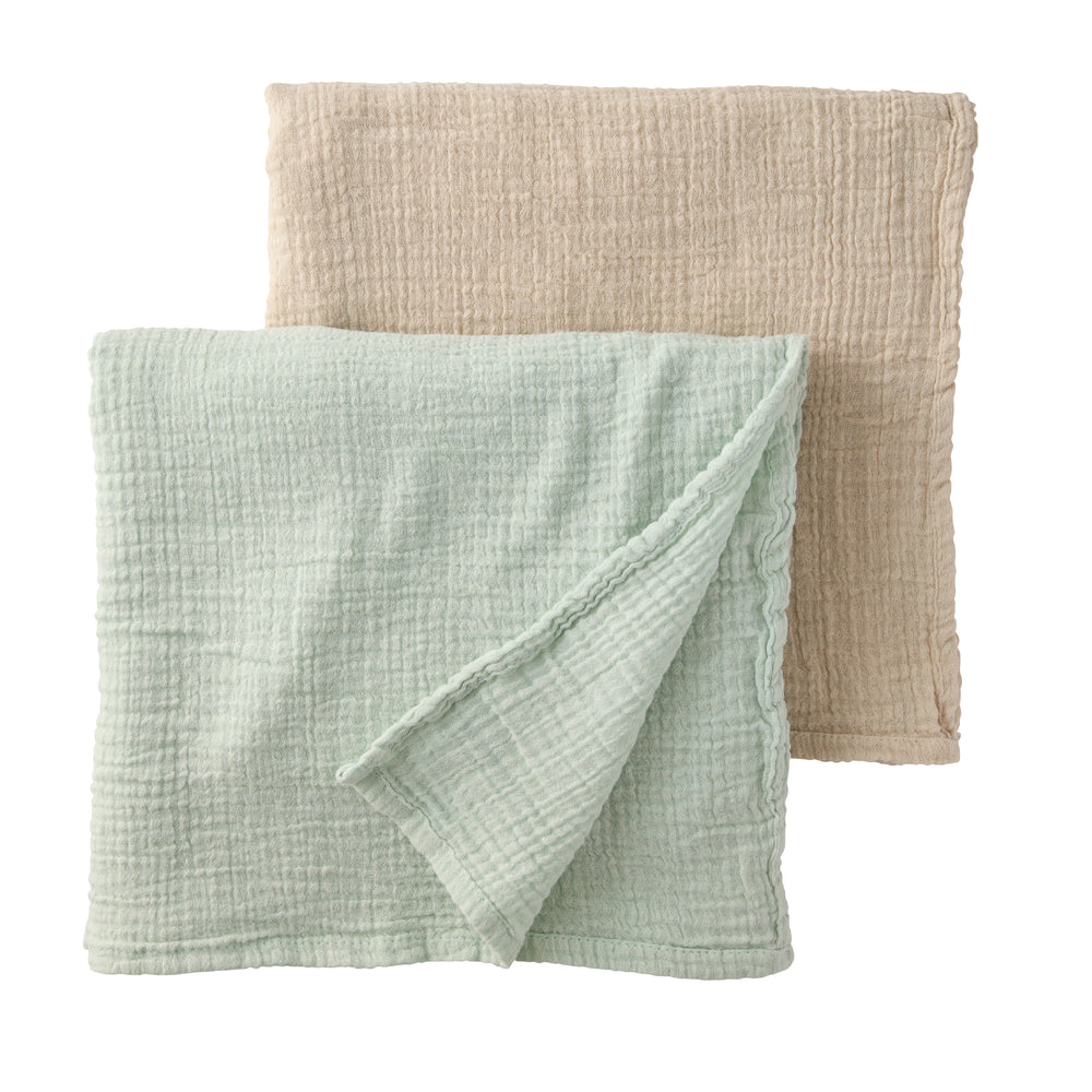 Two textured fabric swaddling blankets, one green and one beige, on a white background.
