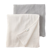 Two folded fabric swaddling blankets, one white and one gray, on a white background.
