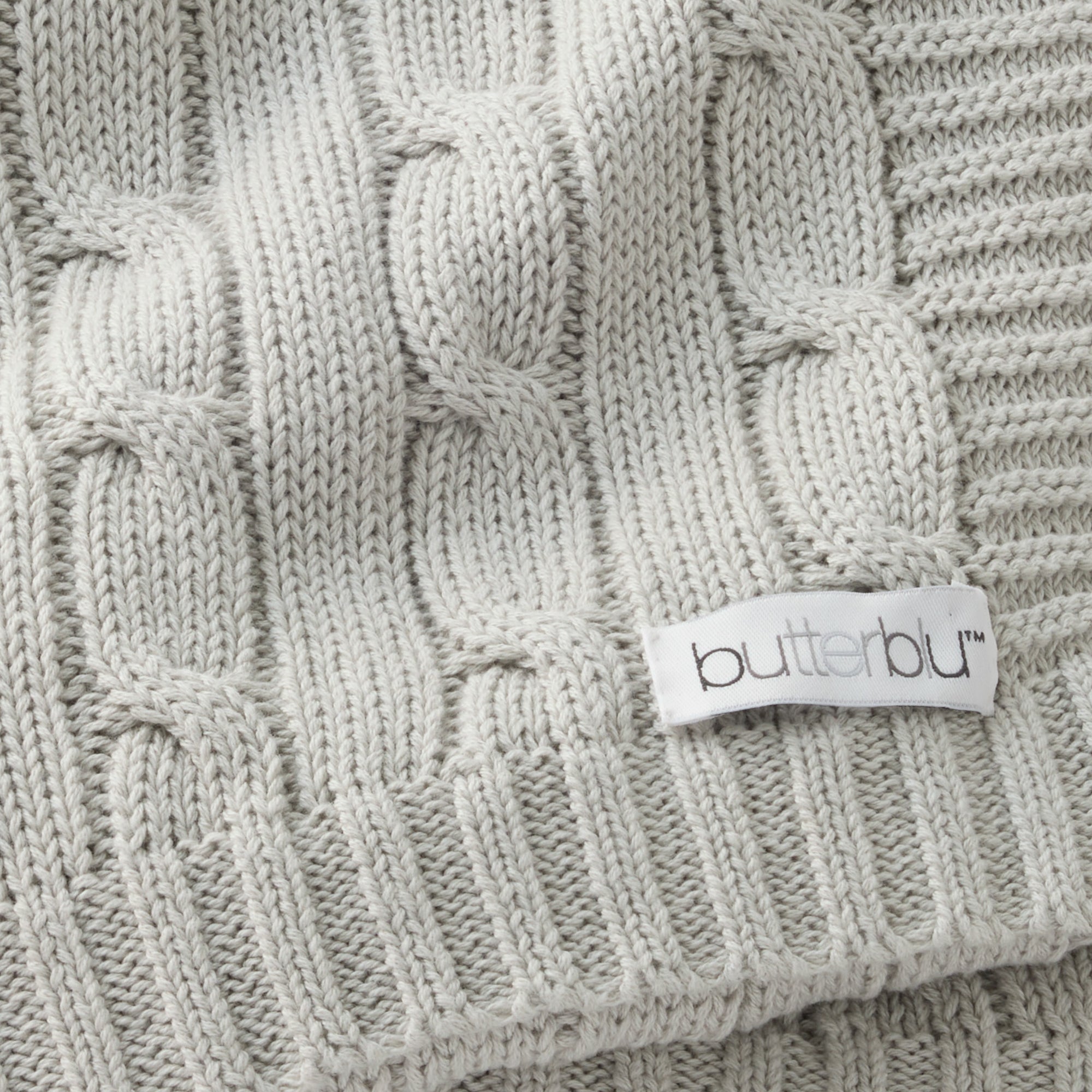 Close-up of a cable knit fabric with a 'butterbur' label.