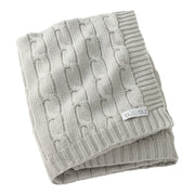 Folded gray knitted blanket with a brand label on a white background