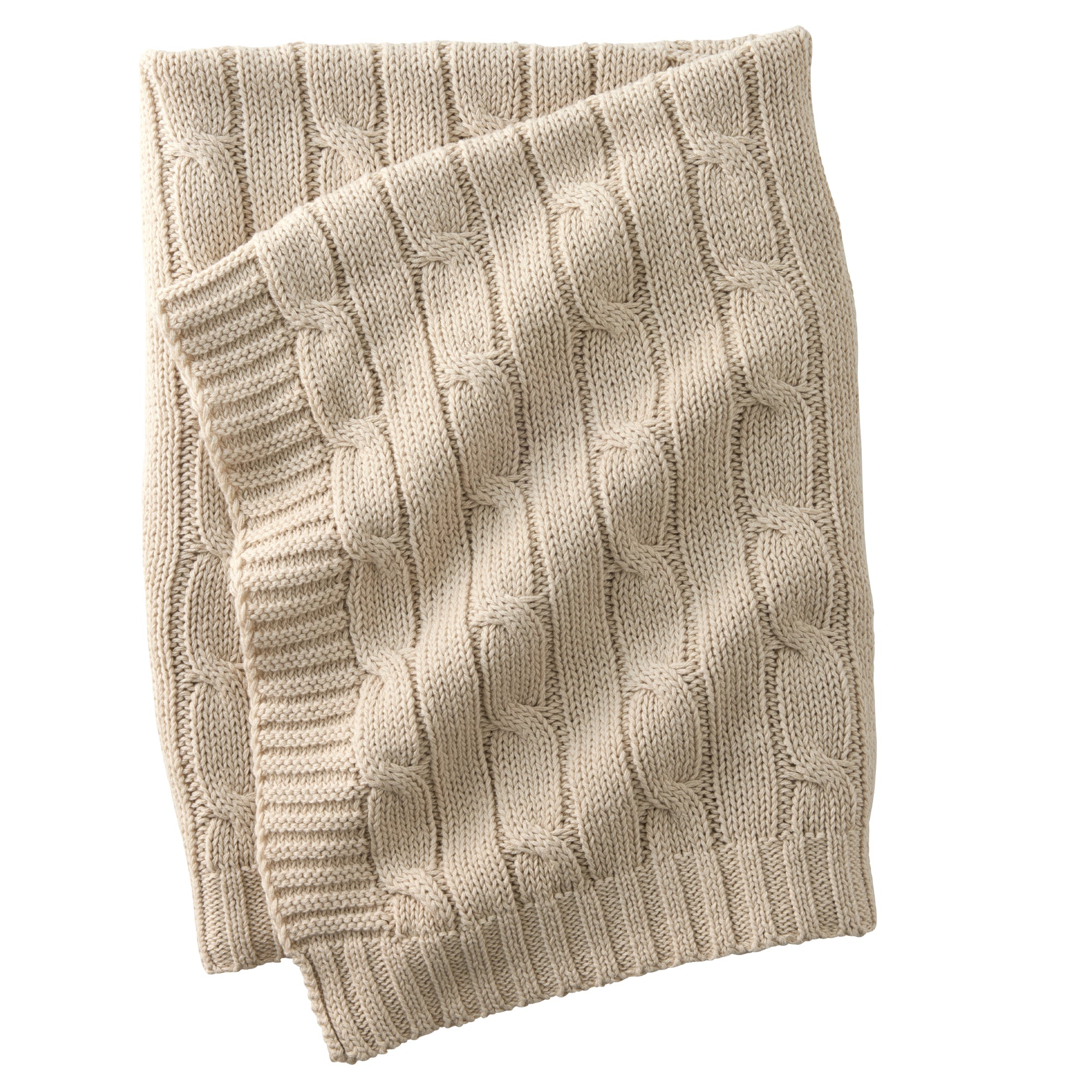 Beige knitted blanket with cable pattern on a white background