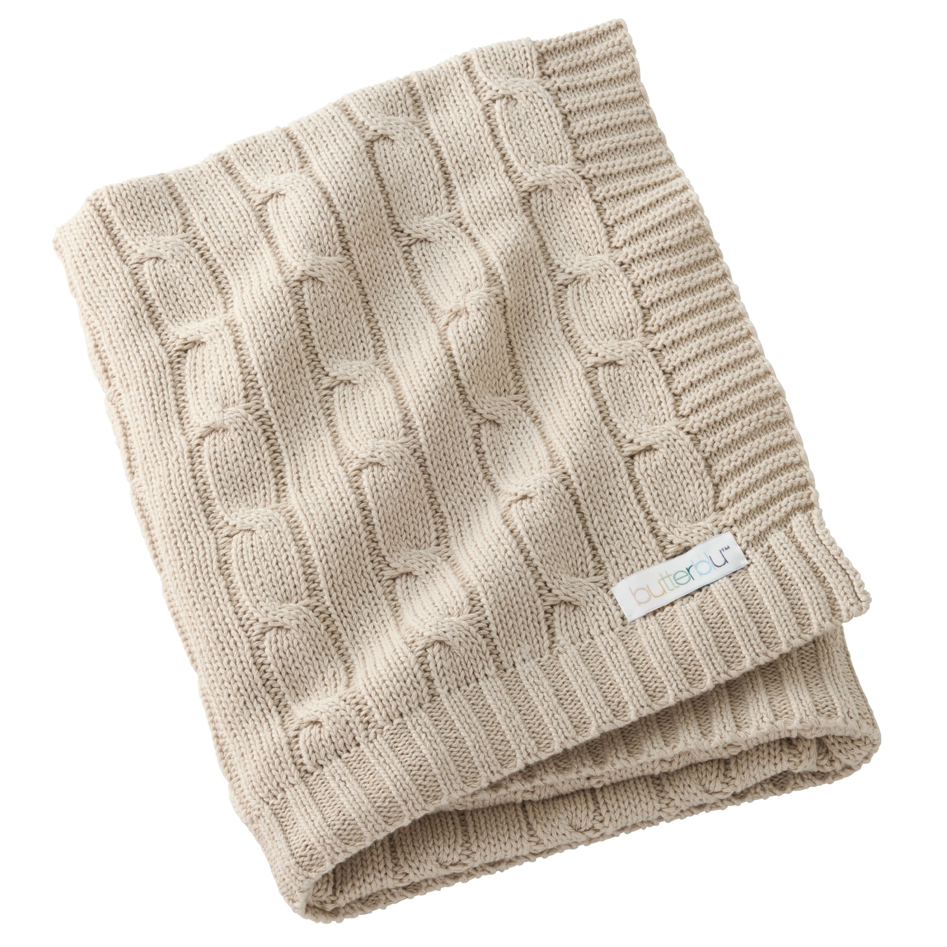 Folded beige knitted blanket with a brand label on a white background