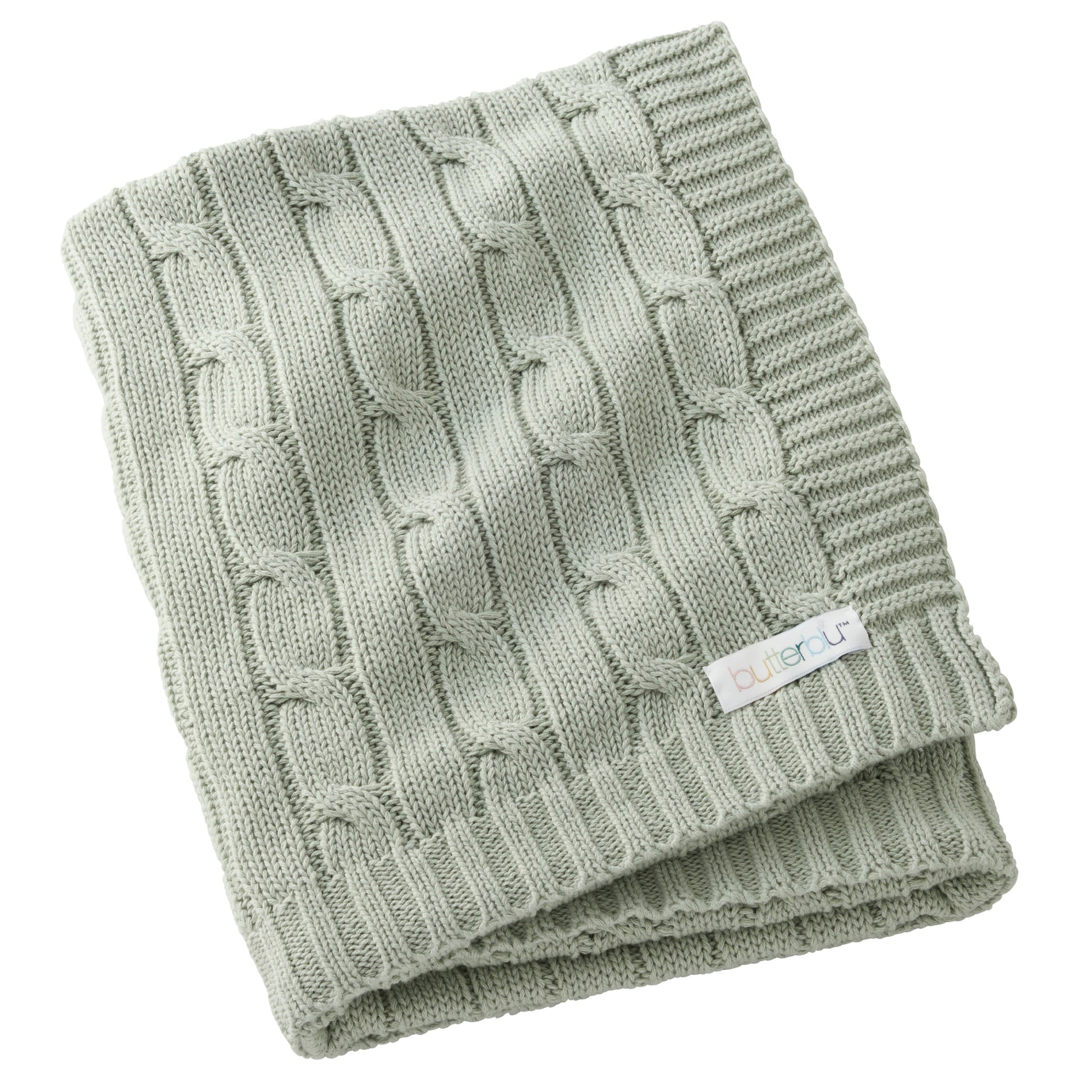 Folded green knitted blanket with a brand label on a white background