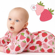 Baby wearing a pink outfit with strawberry pattern, surrounded by cartoon strawberries and flowers.