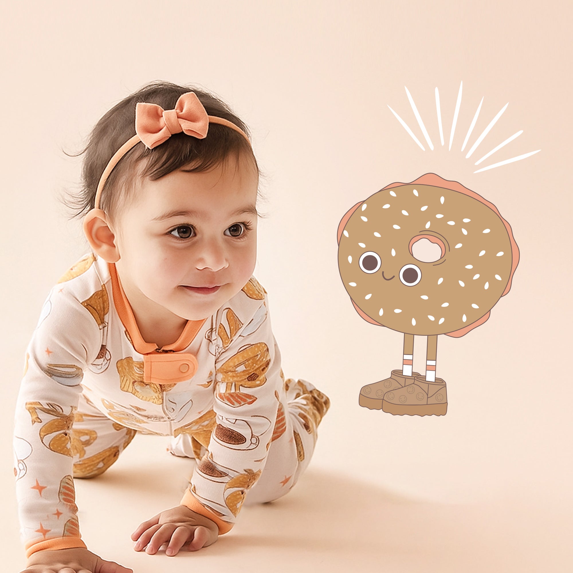 Baby in a patterned outfit with a cartoon donut character on a beige background