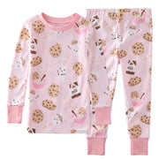 Children's pajama set with cookie and milk pattern on a pink background
