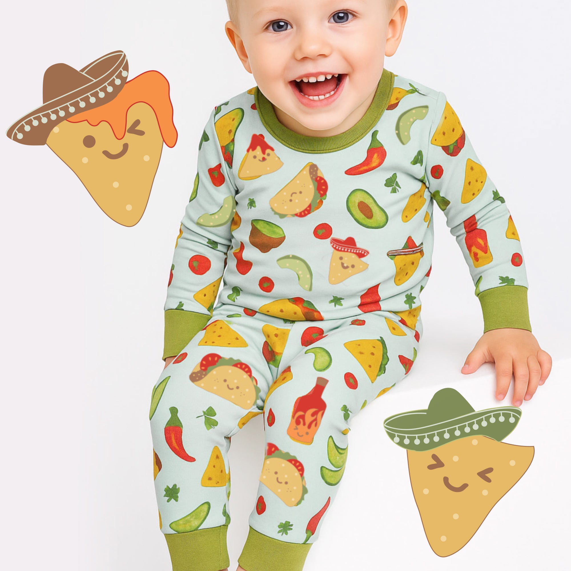 Baby wearing a colorful pajama set with food patterns, surrounded by cartoon tortilla chips on a white background.