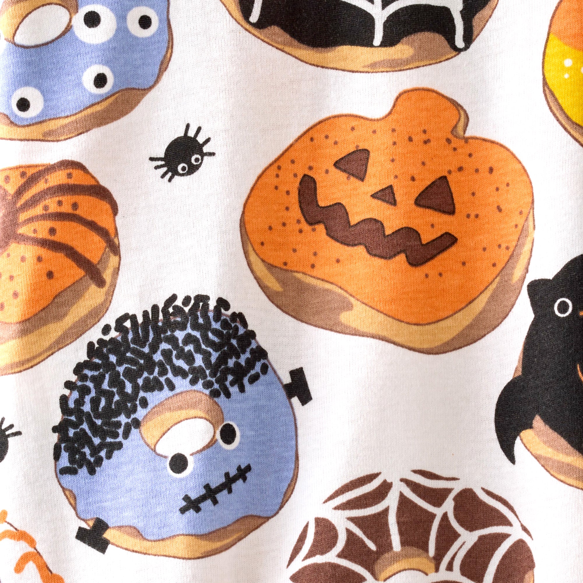 Halloween-themed donuts with various designs on a white background