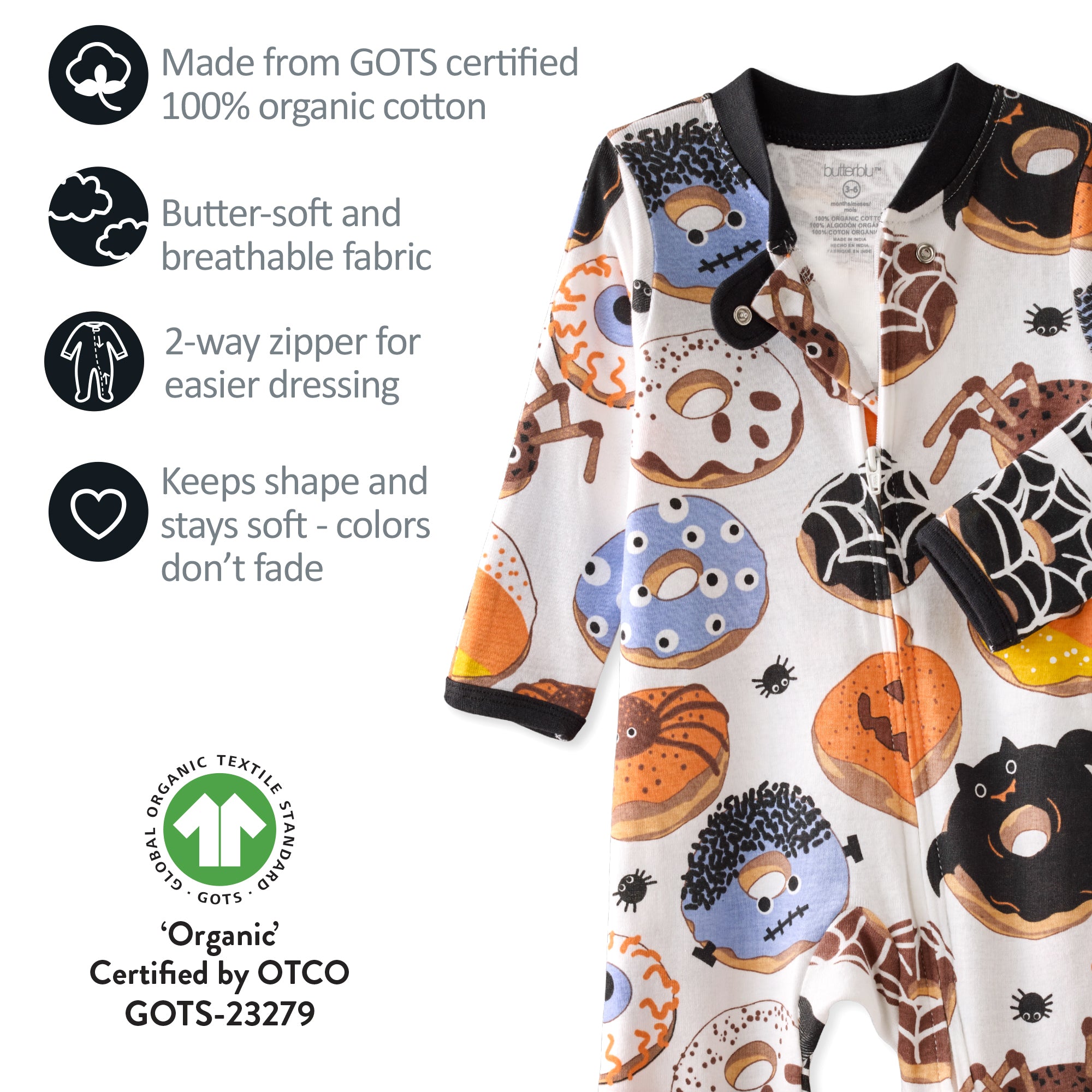 Baby onesie with Halloween-themed design featuring pumpkins, ghosts, and cats on a white background. Text highlights organic cotton certification and fabric properties.