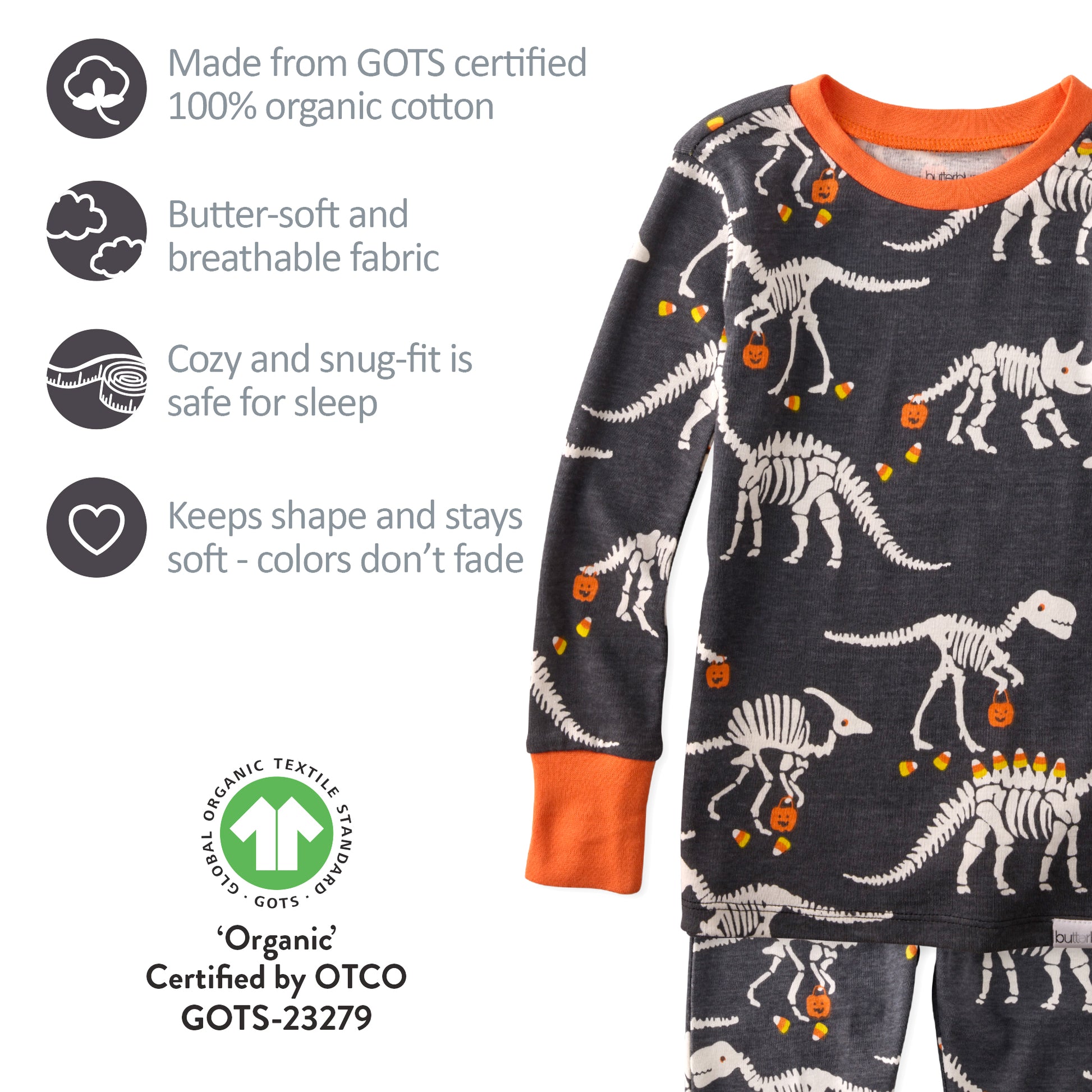 Children's pajamas with dinosaur skeleton pattern on a dark background, featuring organic cotton certification.