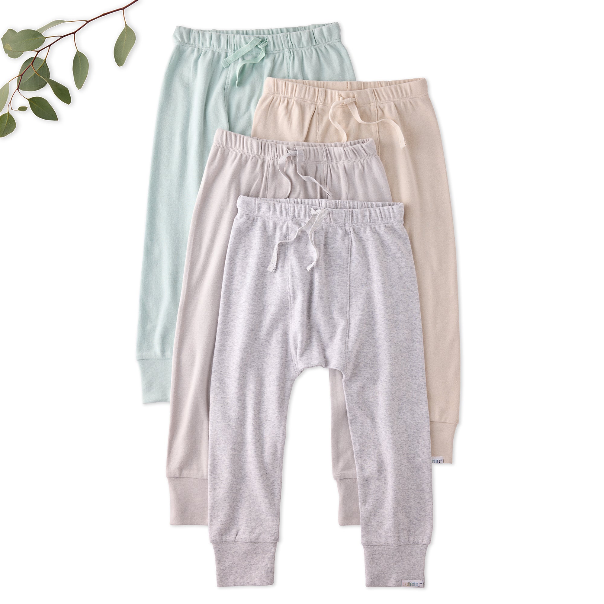 Four pairs of baby pants in light blue, pink, gray, and beige on a white background.