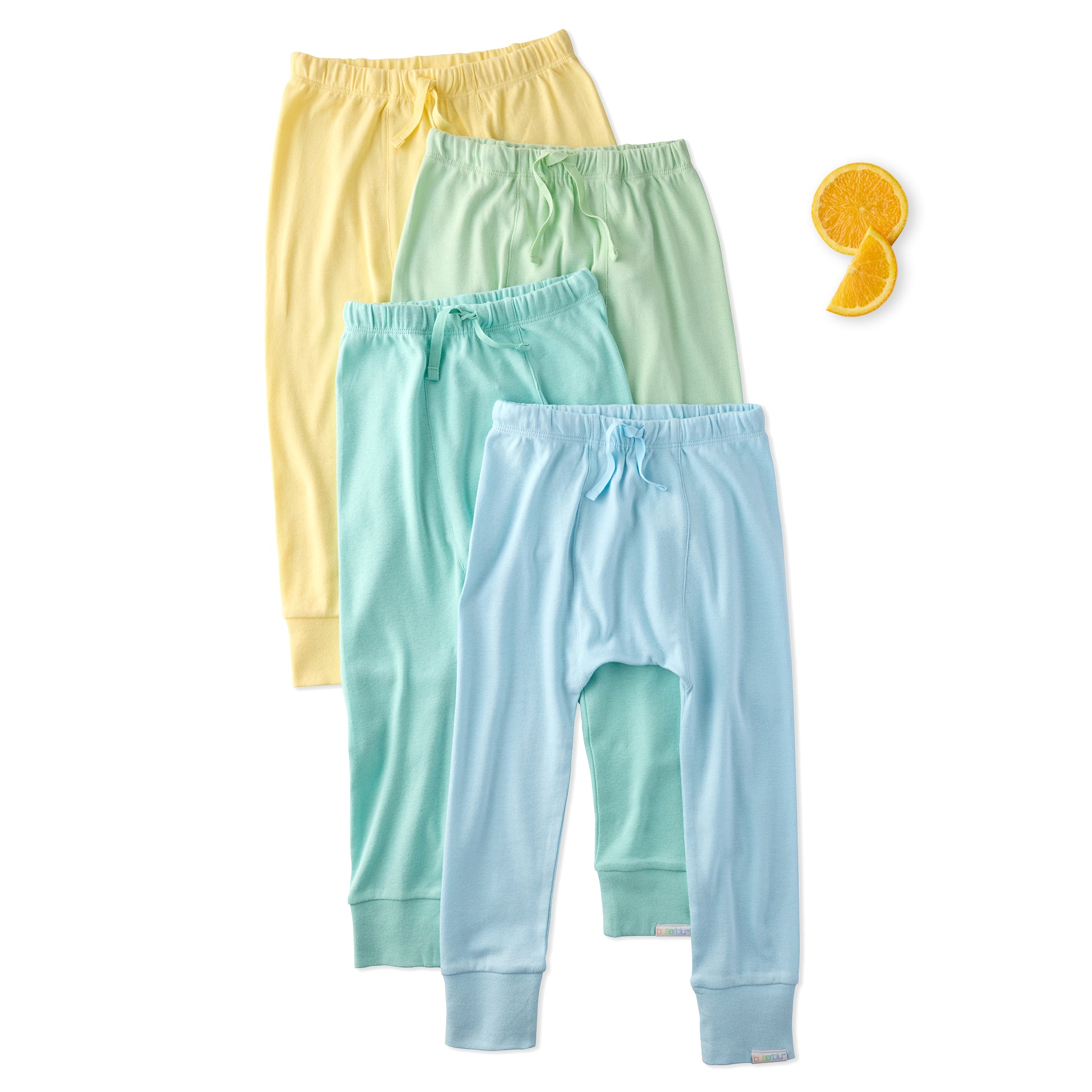 Three pairs of colorful baby pants on a white background