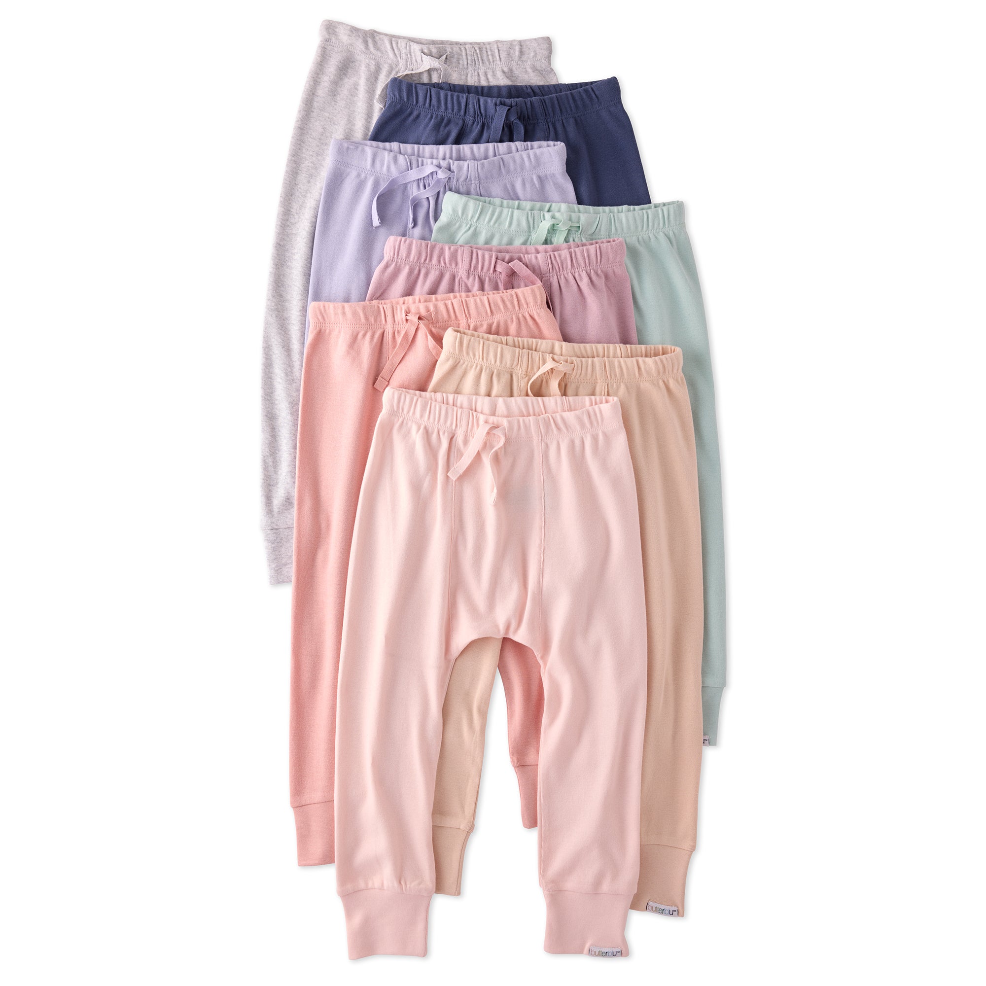 Set of pastel-colored baby pants stacked on a white background