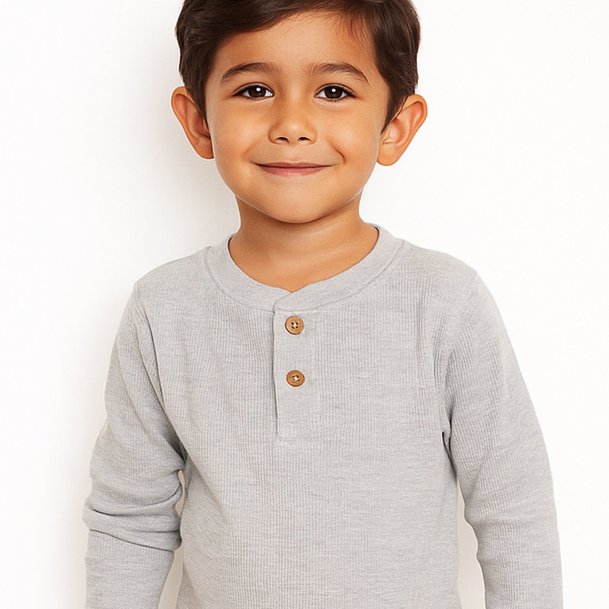 Child wearing a gray long-sleeve henley shirt with buttons on a white background